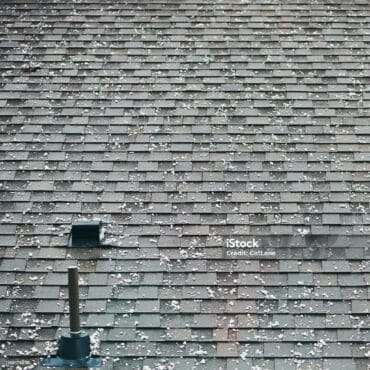 Roof shingles with large hailstones after hail storm